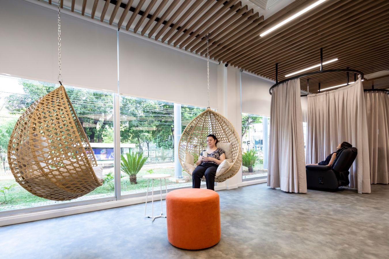 Aseguradora Yacyreta - Employee relaxation zone featuring hanging woven chairs and garden views - Contract Workplaces.jpg
